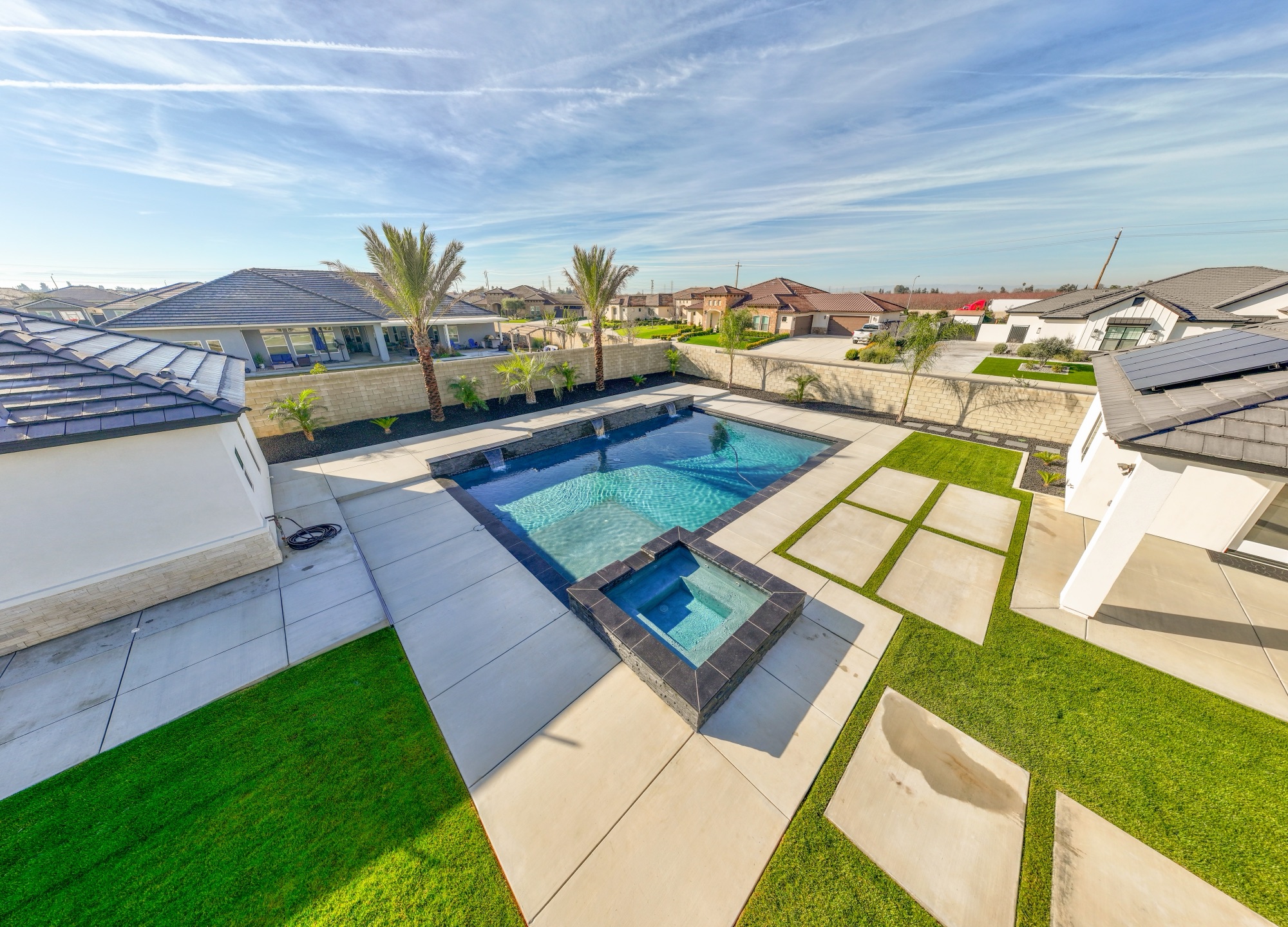 Aerial view of custom gunite pool with raised spa and palms — Bakersfield, CA