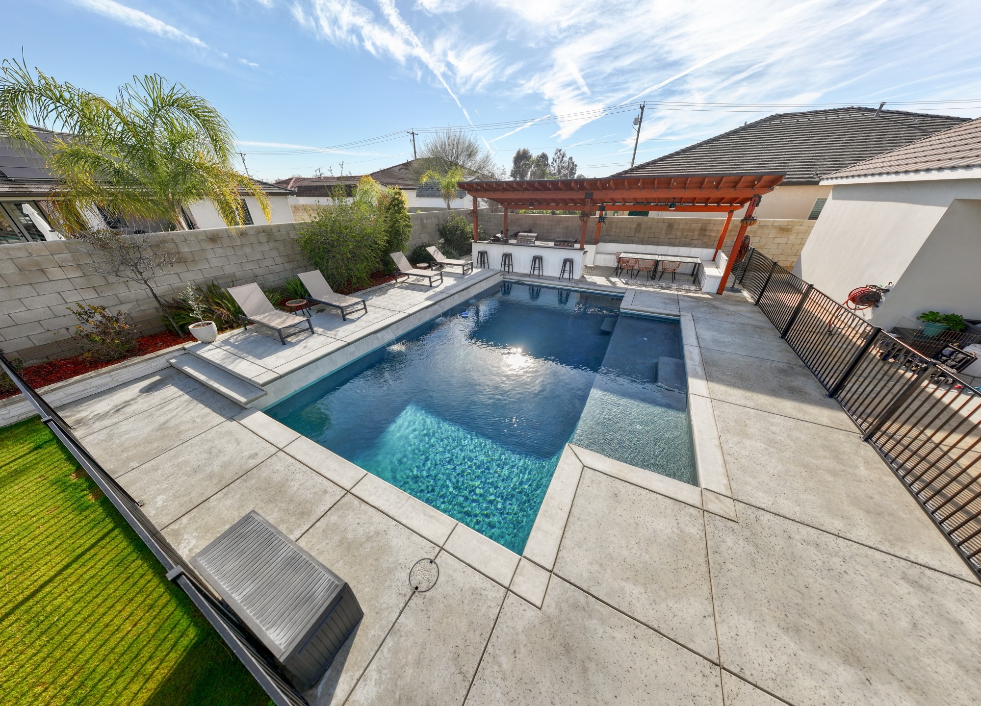 Custom gunite pool with pergola, outdoor bar, and loungers — Bakersfield, CA