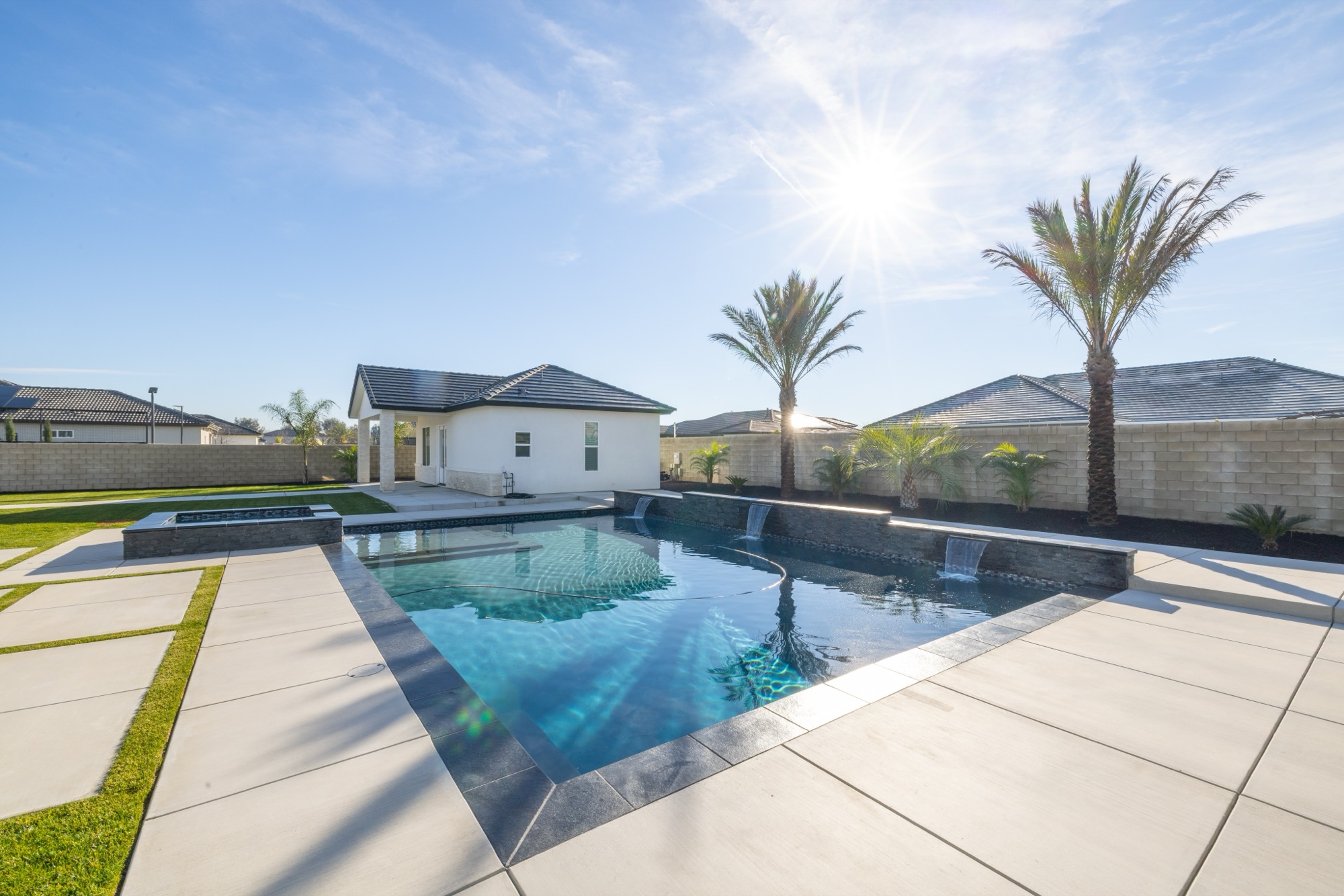 Custom gunite pool with spa, palms, and modern home — Bakersfield, CA