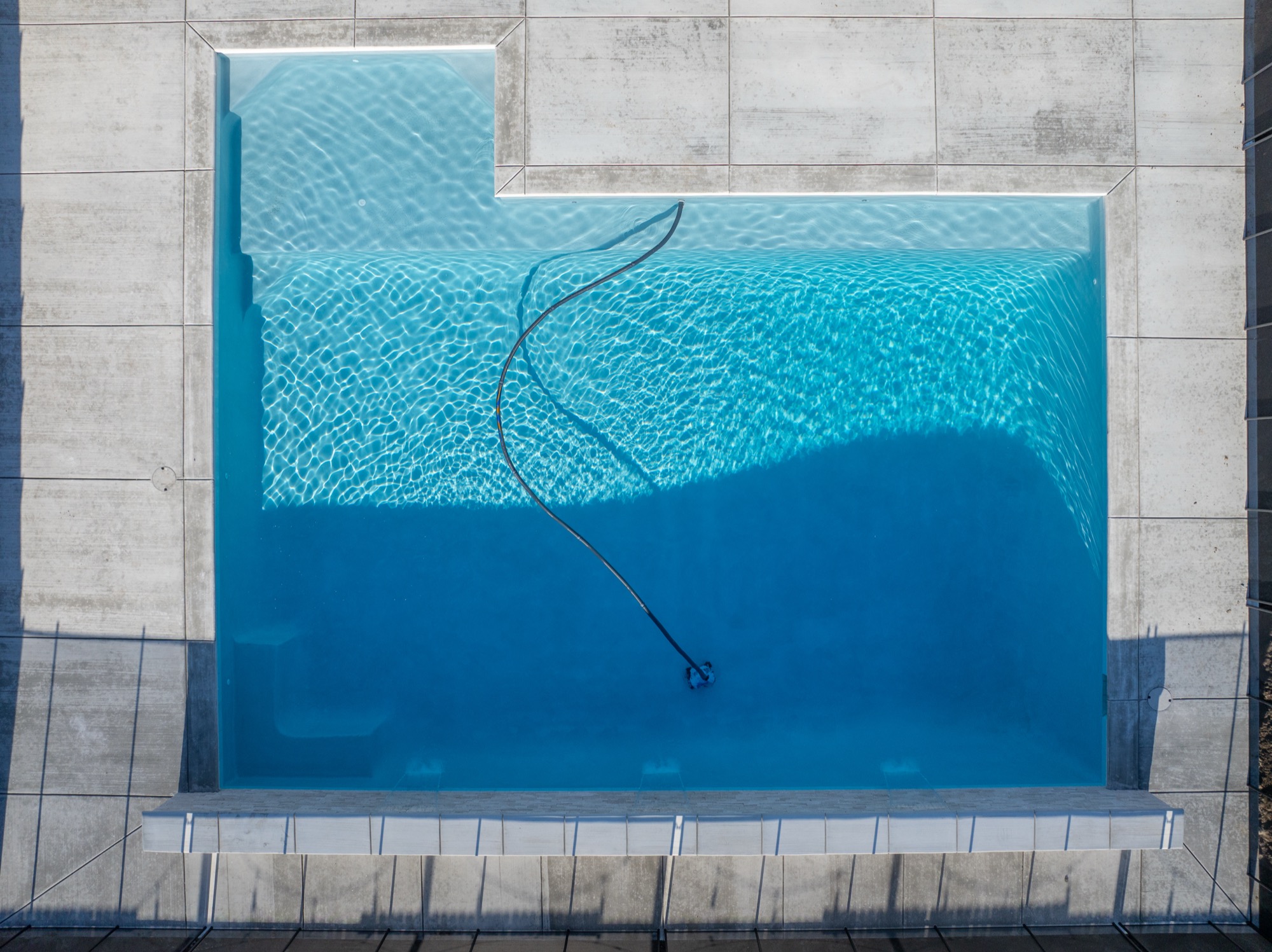 Top-down aerial of pool with blue water